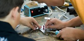 Schüler arbeiten zusammen am einem Werkstück 