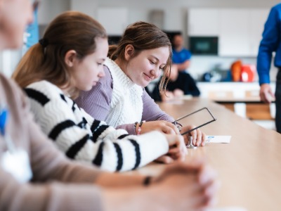 Schülerinnen schneiden mit Bügelsäge Material 